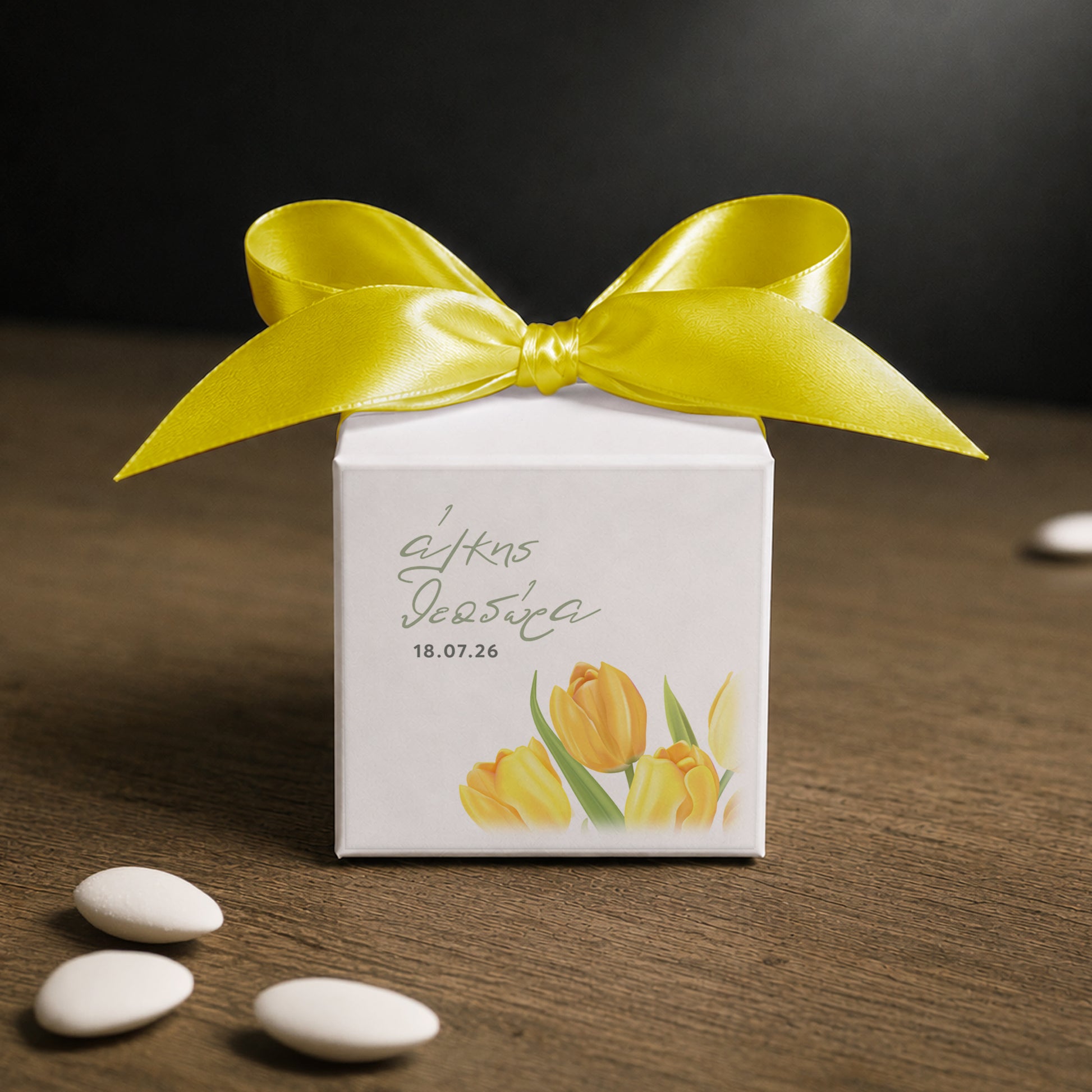 White paper cube favor box 7.5 × 7.5 × 7.5 cm, made from thick 400 gsm paper with printed sticker and ribbon in your choice of color – elegant wedding favor box. Theme: Yellow Tulip.
