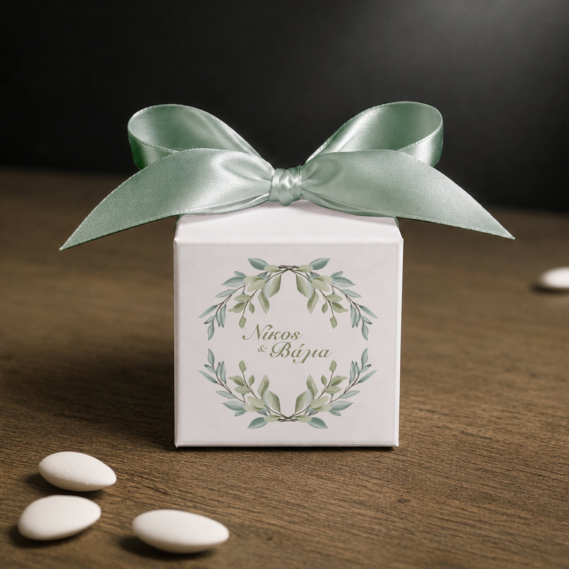 White paper cube favor box 7.5 × 7.5 × 7.5 cm, made from thick 400 gsm paper with printed sticker and ribbon in your choice of color – elegant wedding favor box. Theme: Greenery.

