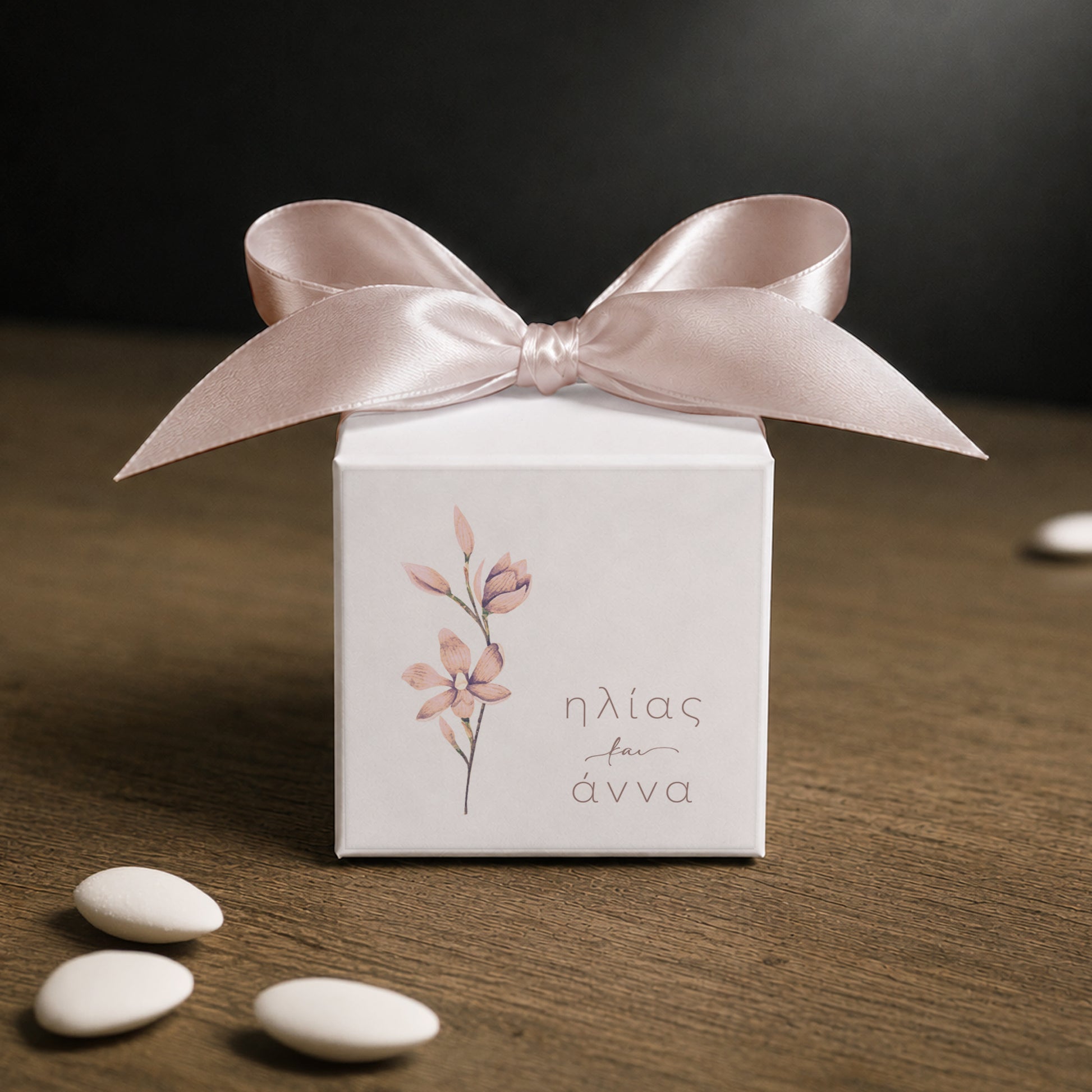 White paper cube favor box 7.5 × 7.5 × 7.5 cm, made from thick 400 gsm paper with printed sticker and ribbon in your choice of color – elegant wedding favor box. Theme: Nude Flower.
