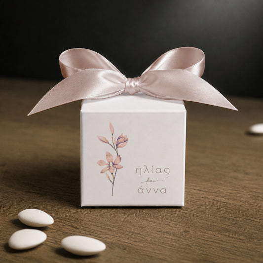 White paper cube favor box 7.5 × 7.5 × 7.5 cm, made from thick 400 gsm paper with printed sticker and ribbon in your choice of color – elegant wedding favor box. Theme: Nude Flower.
