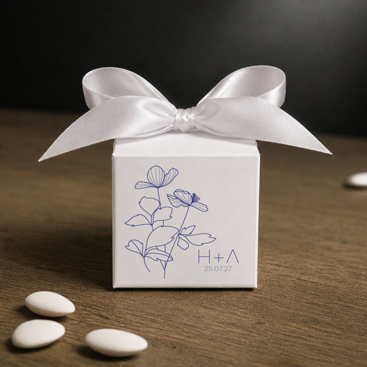White paper cube favor box 7.5 × 7.5 × 7.5 cm, made from thick 400 gsm paper with printed sticker and ribbon in your choice of color – elegant wedding favor box. Theme: Blue Anemone.
