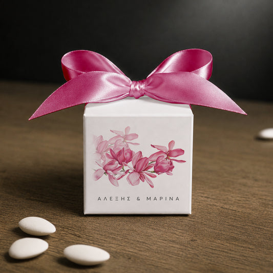 White paper cube favor box 7.5 × 7.5 × 7.5 cm, made from thick 400 gsm paper with printed sticker and ribbon in your choice of color – elegant wedding favor box. Theme: Magnolia.
