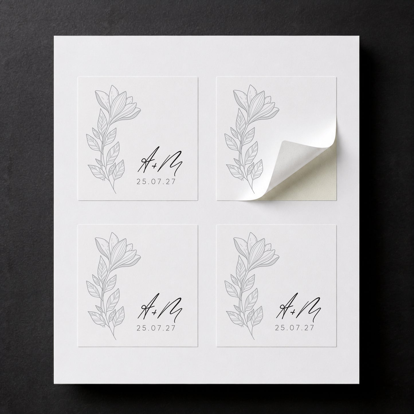 Sheet with four printed Line Black Flowers wedding favor stickers for white paper cube favor boxes.
